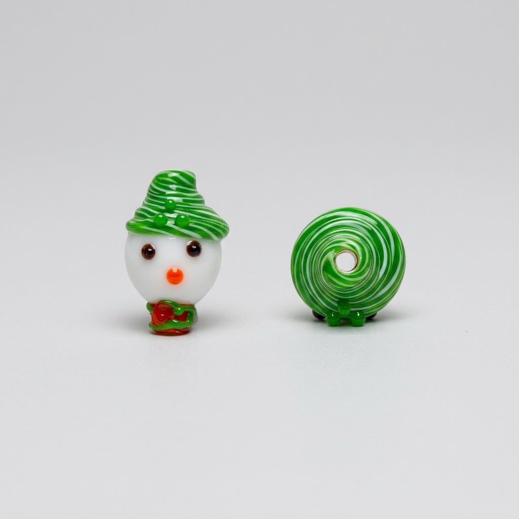 A pair of green and white swirled glass beads shaped like a snowman and a lollipop, shown on a plain white background.