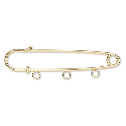 A gold safety pin style pendant or charm with three small hanging loops along the bottom bar, shown on a plain white background.