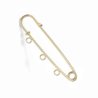 A gold safety pin style pendant or charm with three small hanging loops along the bottom bar, shown on a plain white background.