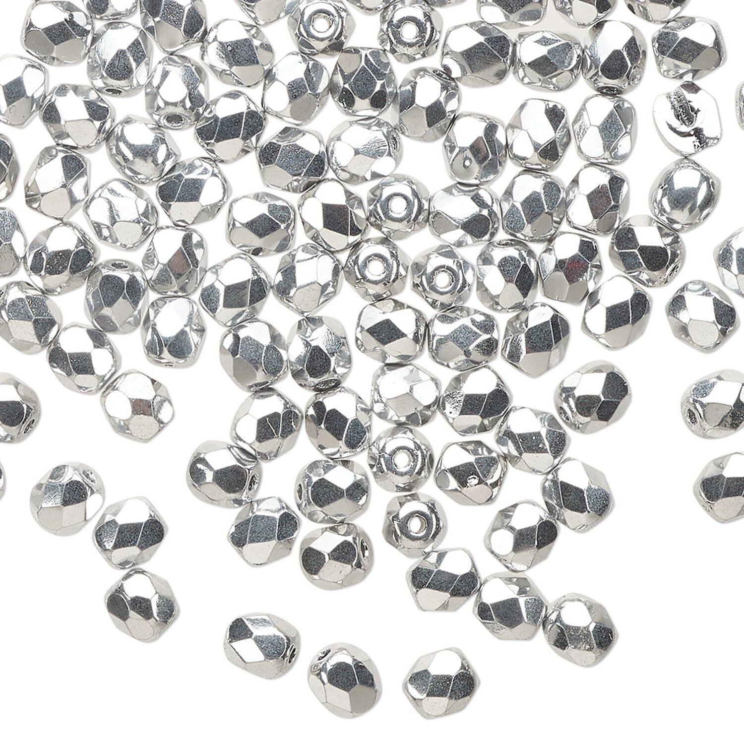 A pile of small silver faceted beads scattered on a plain white background.