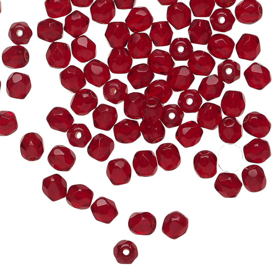 Red faceted beads on a white background