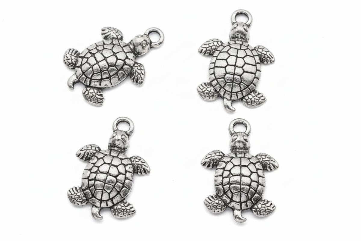 Four silver sea turtle charms with detailed textured shells, arranged in a 2x2 grid on a plain white background.