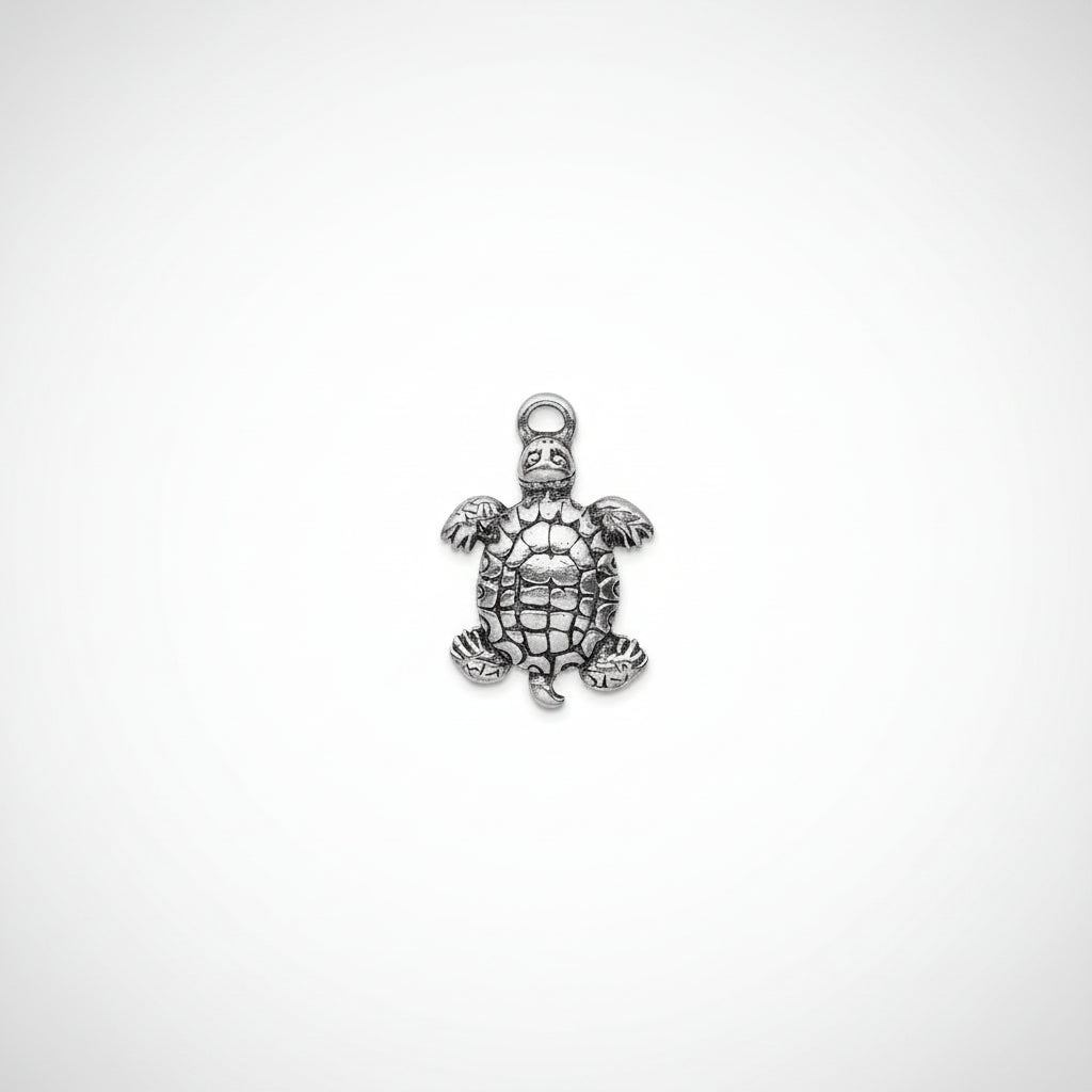A silver-toned metal turtle charm pendant with a textured, antiqued finish and a hanging loop at the top, shown against a plain white background.