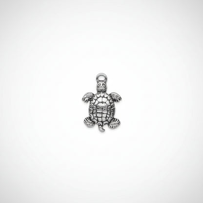 A silver-toned metal turtle charm pendant with a textured, antiqued finish and a hanging loop at the top, shown against a plain white background.