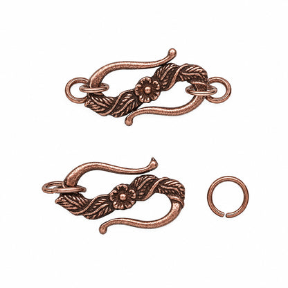 Copper-toned metal jewelry findings set featuring a decorative floral and leaf hook clasp shown in two assembled and open positions, plus a separate open ring clasp on a plain white background.