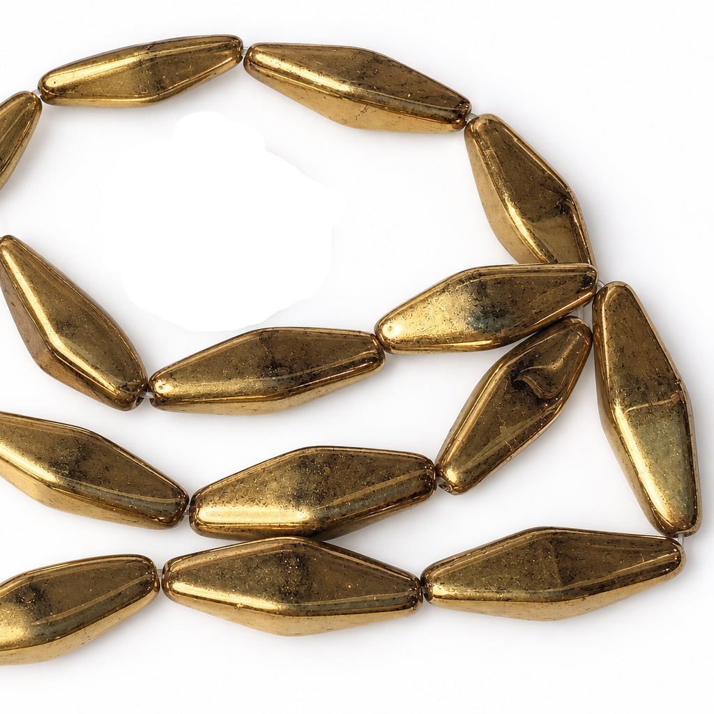 A close-up of metallic gold elongated teardrop-shaped beads on a white background, with a US dime coin placed in the upper left for scale.