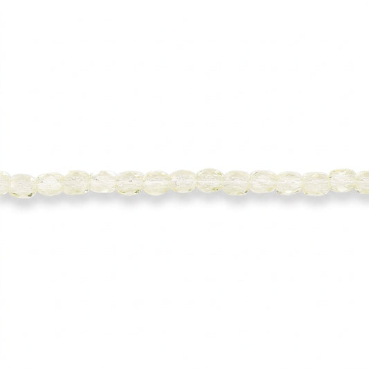 A single strand of faceted round beads in a pale yellow color, laid horizontally against a solid white background.