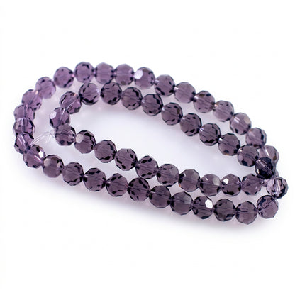 A strand of faceted  beads with a subtle purple tint, arranged in two loops on a plain white background.
