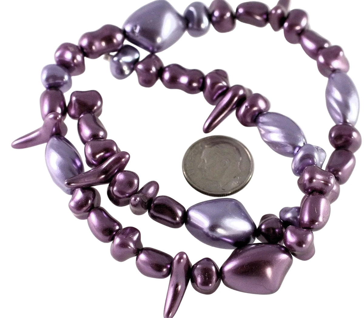 A multi-strand beaded necklace in a metallic purple/plum color, displayed on a white background with a US quarter coin for scale.