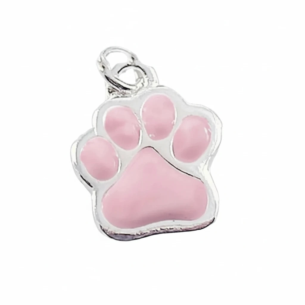 A silver paw print charm pendant with a glossy pink enamel fill, shown on a plain white background.