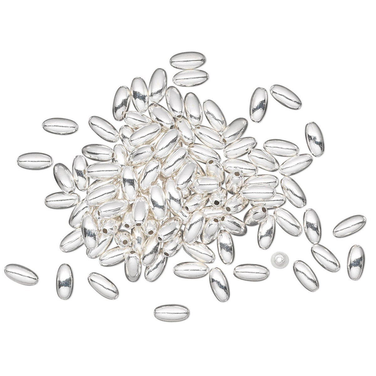 A pile of small, polished silver oval beads with a glossy finish, scattered on a plain white background.