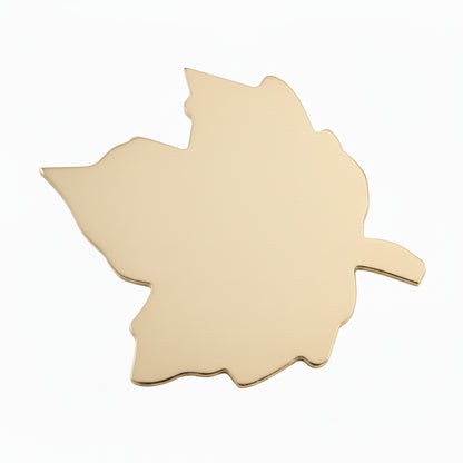 Unpainted wooden leaf-shaped cutouts shown on a white background, with a penny placed near them for scale.