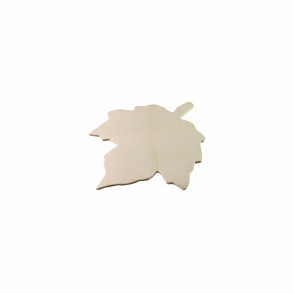Unpainted wooden cutouts in a leaf shape, showing a light natural wood grain texture on a neutral gray background.