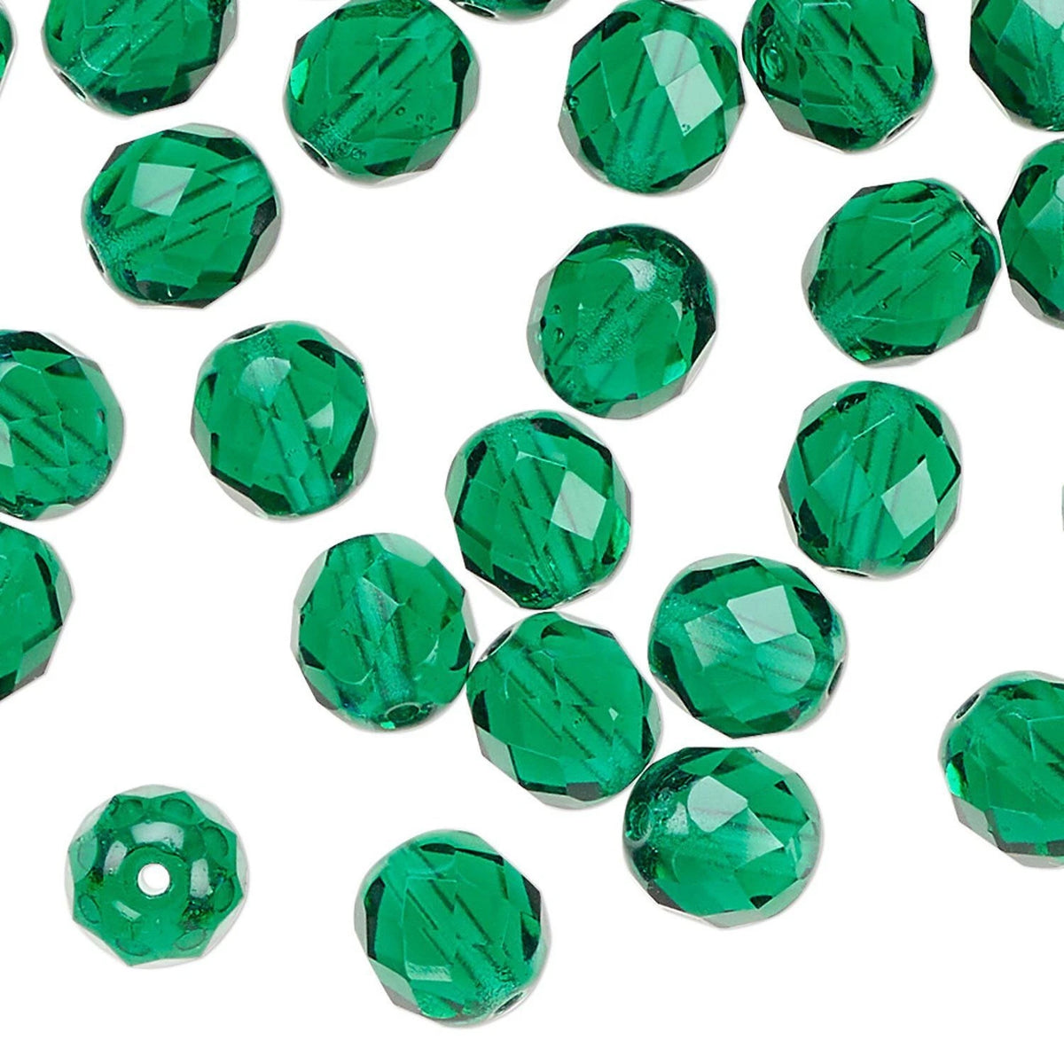 Green faceted round beads scattered on a white background, with one bead shown without a center hole.