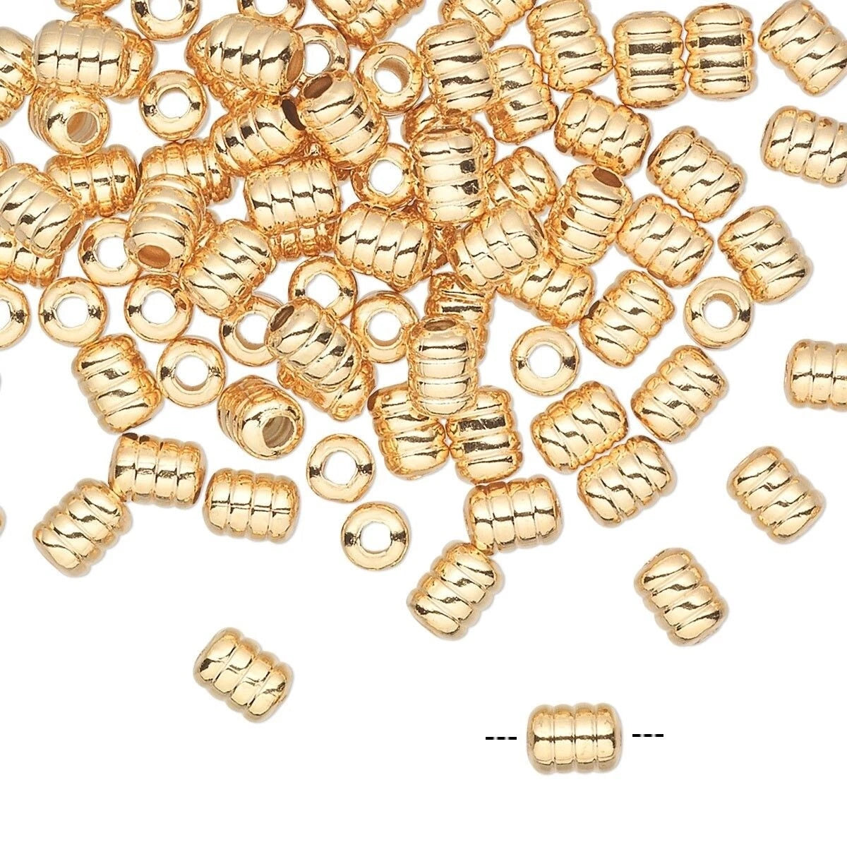 A pile of small metallic gold cylindrical beads with a ribbed texture, scattered on a plain white background. A single bead is shown near the bottom with dashed lines indicating its shape and size.