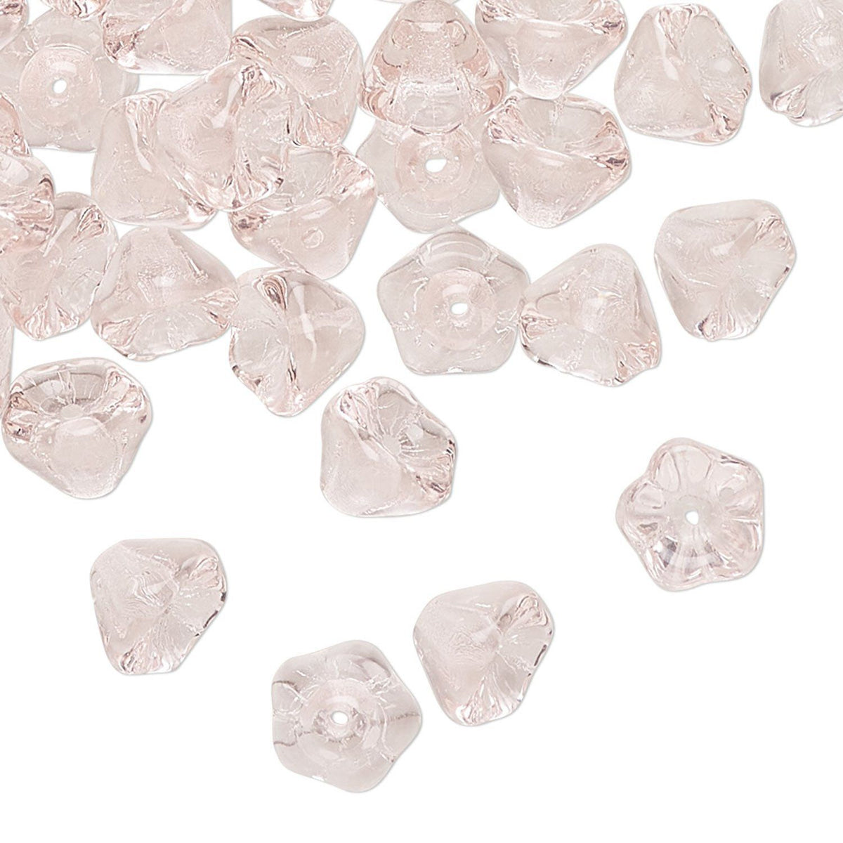 PINK glass flower-shaped beads scattered on a white background.