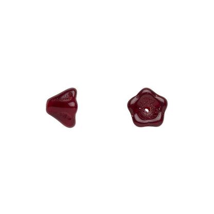 Two small glossy dark red glass beads, one triangular and one five-pointed star, shown on a plain white background.