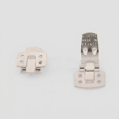 Two silver metal hinge SHOE CLIP latches on a plain white background, one showing the front and the other showing the back with 'BLUETTE MADE IN FRANCE' stamped on it.