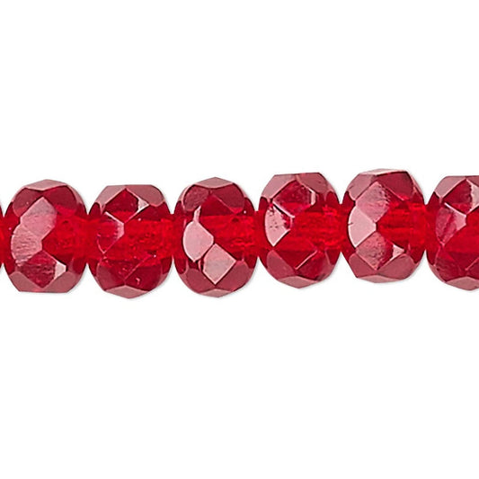 A close-up horizontal row of faceted red glass beads on a plain white background.