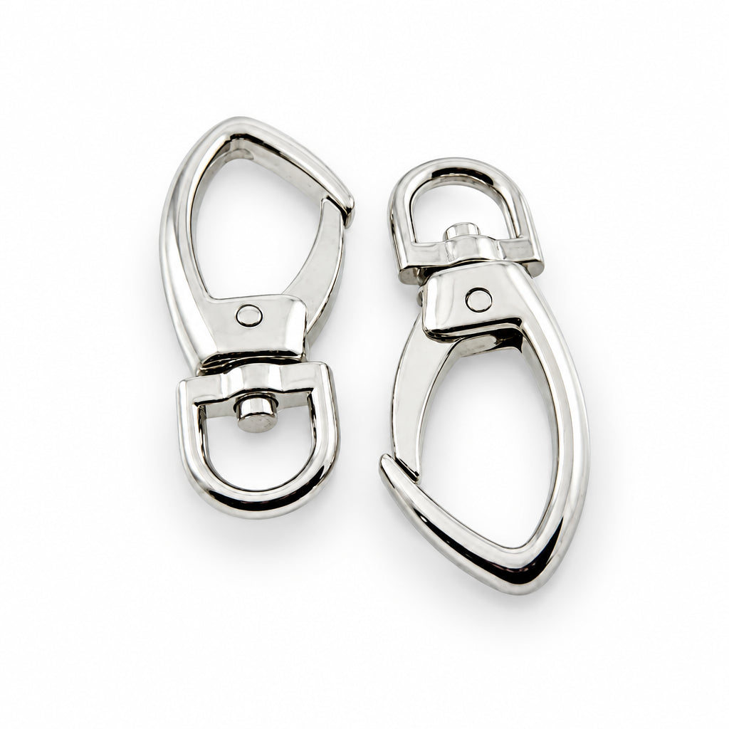 Two polished silver-tone metal swivel snap hooks or lobster clasp components shown on a plain light background, with a coin partially visible at the top for scale.
