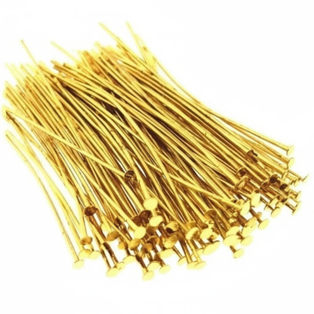 A pile of gold-colored metal wire jump rings with flat circular ends, arranged on a plain white background.