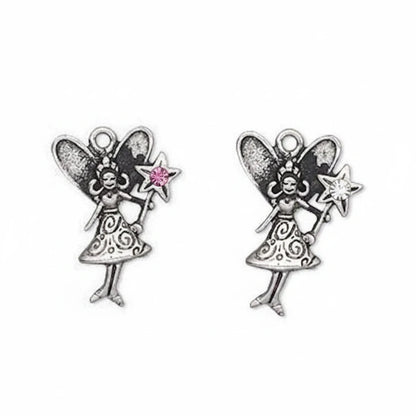 A pair of silver fairy jewelry charms with wings, holding a star wand with a pink gemstone and a silver star wand, on a plain white background.