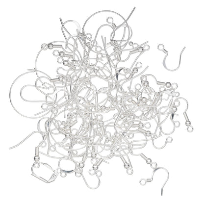 A pile of silver-colored metal ear hooks and ear wires arranged on a plain white background.