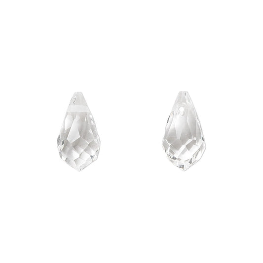 A pair of clear faceted teardrop-shaped crystal beads on a solid white background.