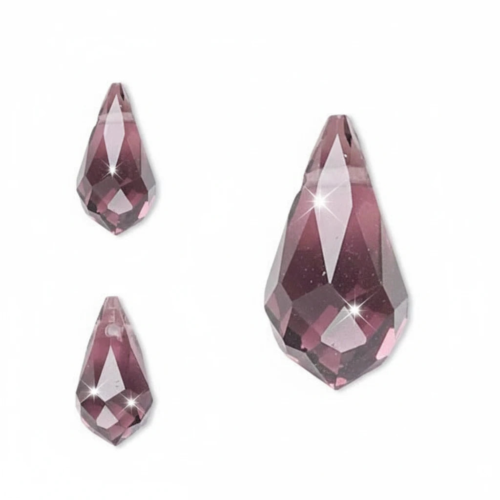 Faceted teardrop-shaped gemstone beads in a dusty rose pink color, shown on a white background with one large close-up inside an oval outline and two smaller views on the left.