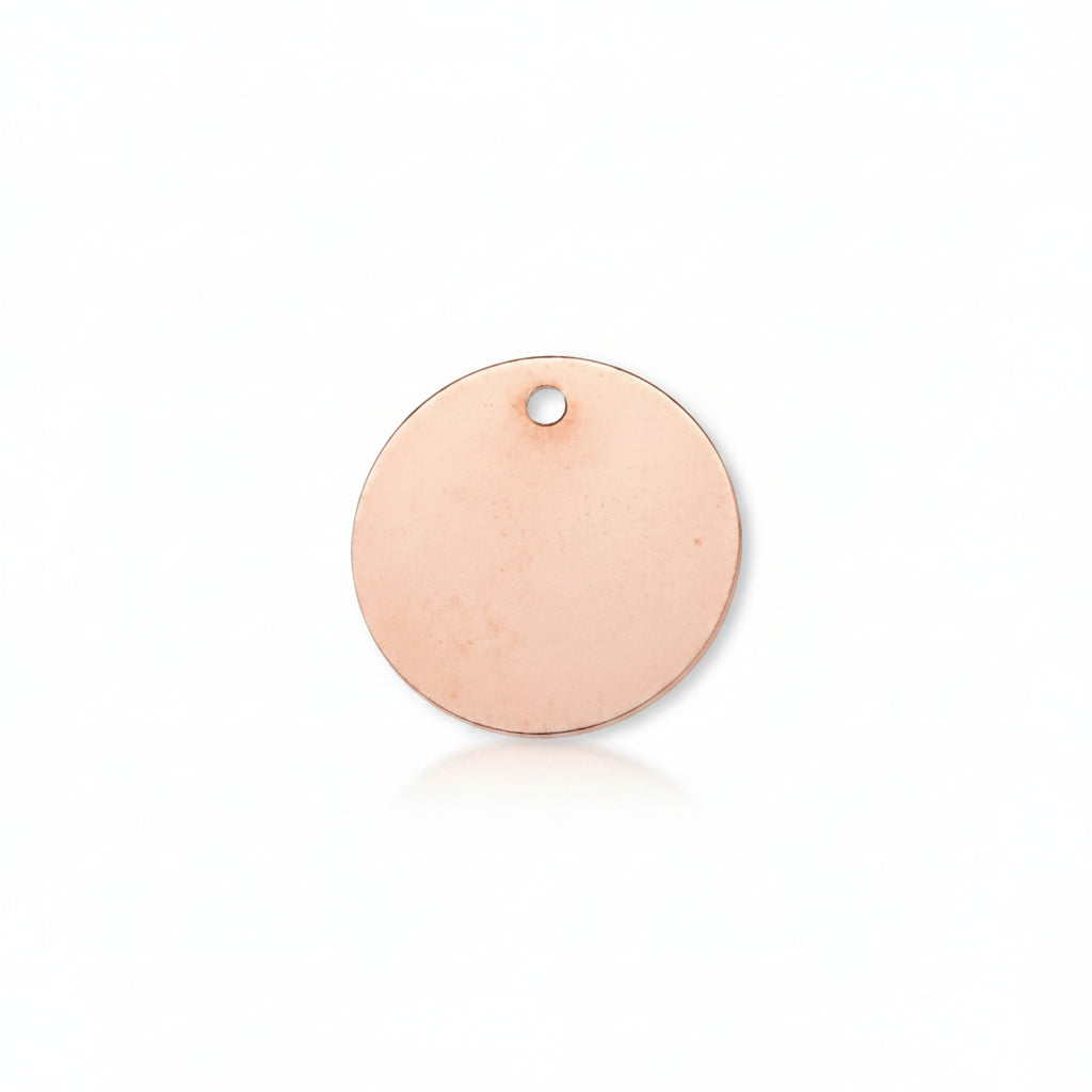 A blank round copper disc pendant with a small hole at the top, shown on a solid white background.