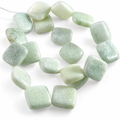 A strand of polished, rounded rectangular gemstone beads in pale green and cream-white, arranged in a loose circle on a white background.