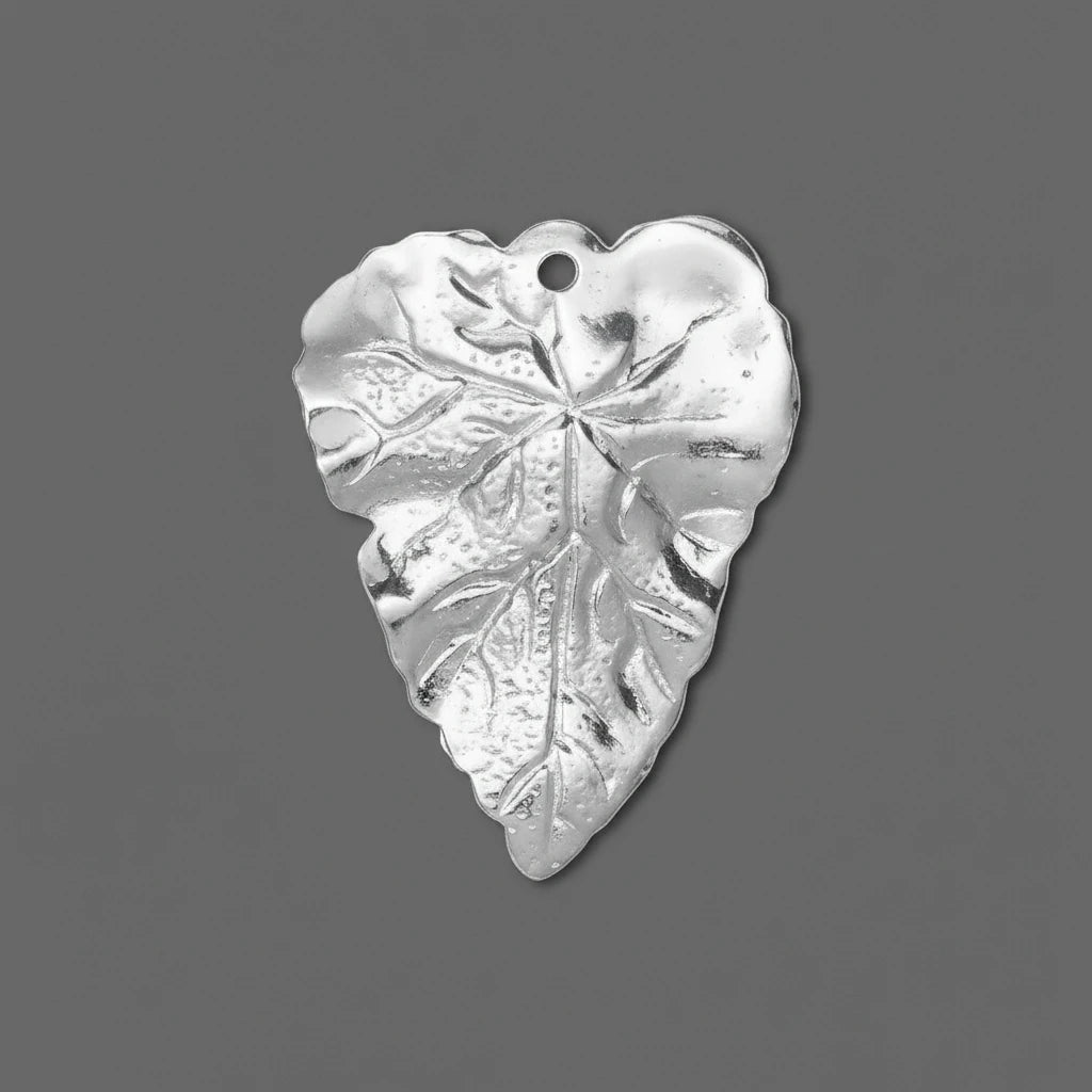 A single silver-toned metal leaf-shaped charm with a small hanging hole, shown on a plain gray background.