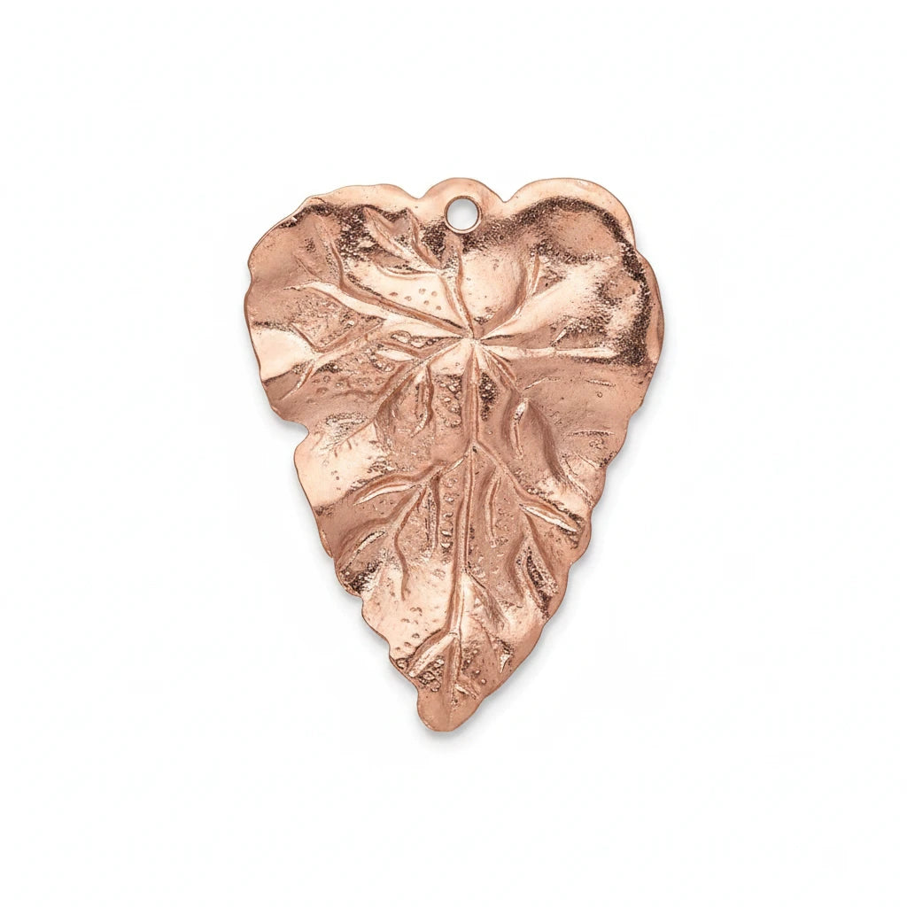 A single heart-shaped metallic charm with a leaf-like embossed pattern and a small hanging hole, shown on a plain white background.
