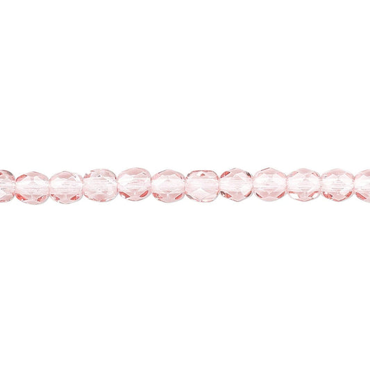 A single strand of faceted light pink glass beads aligned horizontally on a plain white background.