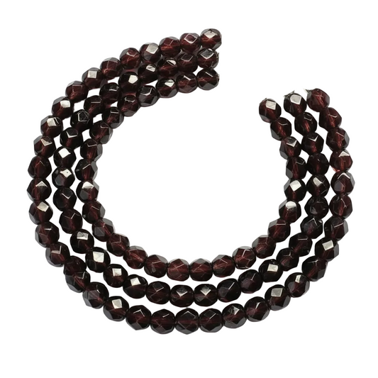 A multi-strand beaded necklace featuring faceted dark red garnet beads and a silver-tone lobster clasp, displayed on a clean white background.