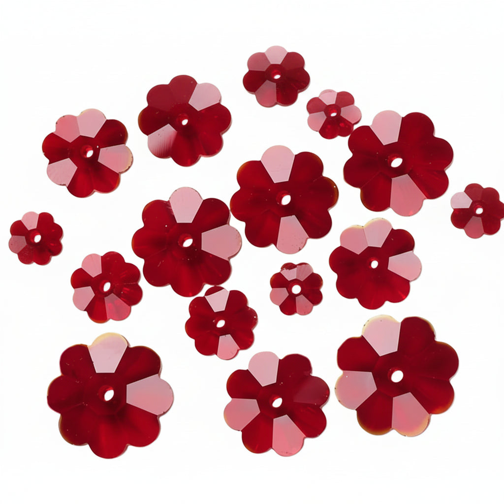 Red flower-shaped craft sequins with a faceted, multi-point design and a central hole, scattered on a plain white background.
