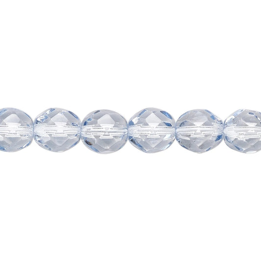A close-up of faceted round beads in a pale icy blue color, arranged in a horizontal line against a solid white background.