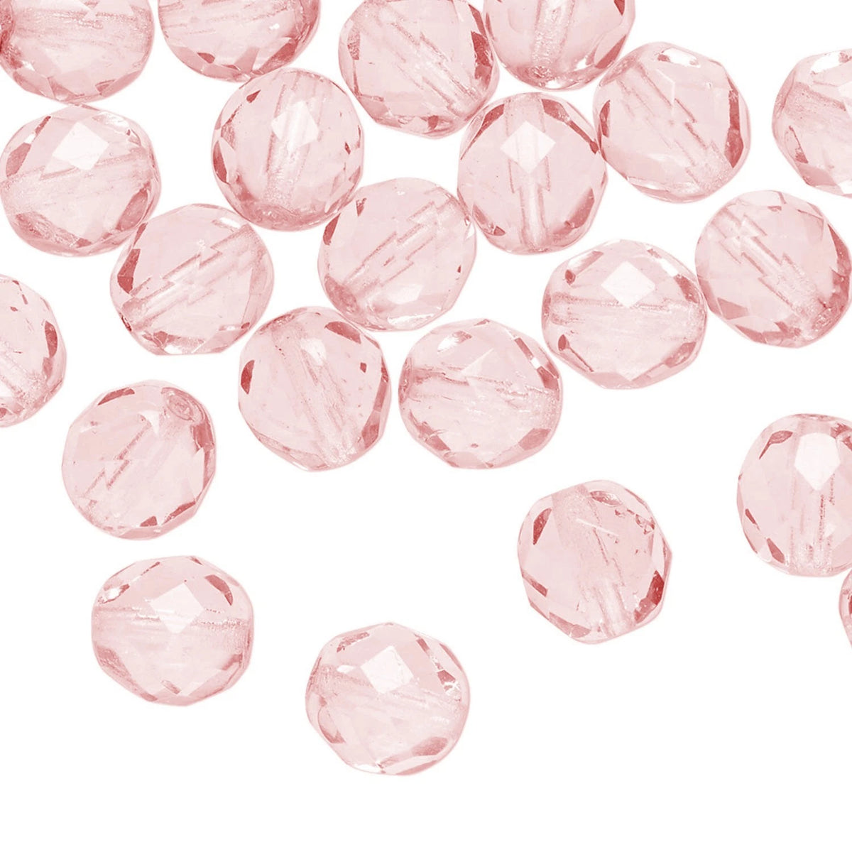 Light pink faceted glass beads scattered on a plain white background.
