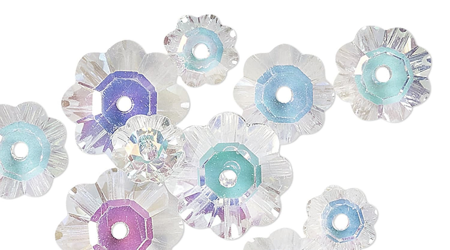 Decorative flower-shaped beads with pastel colors on a white background