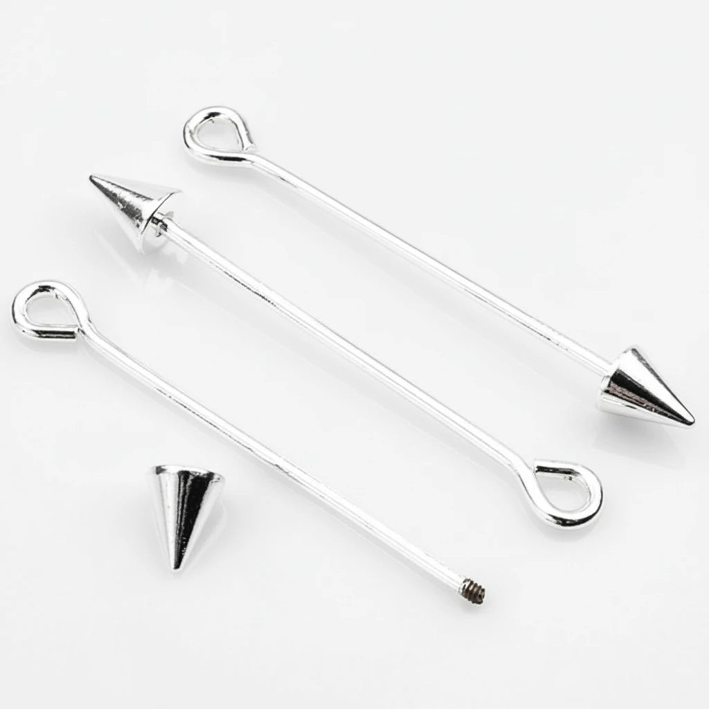 Three silver-toned metal barbell-style findings with looped ends and pointed cone tips, shown on a clean white background. One cone tip is placed separately below.