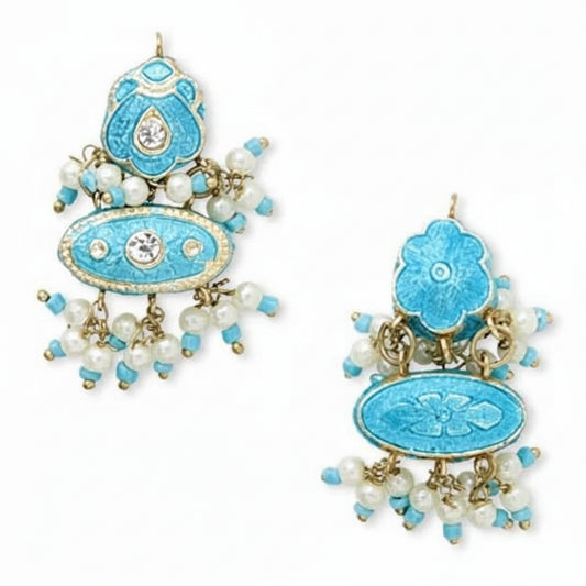 A pair of traditional Indian jhumka earrings with turquoise blue enamel, gold-plated metal, and white pearl bead drops, shown against a plain white background.