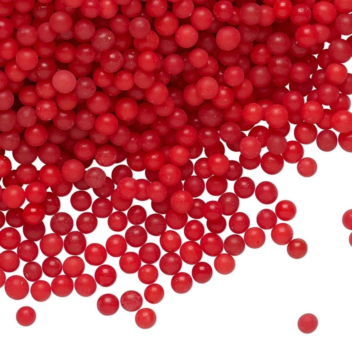 Red round craft beads scattered across a white background.