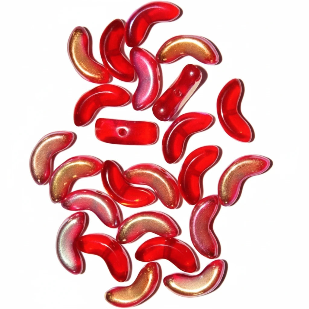 A pile of small, glossy, curved red glass beads with a metallic gold sheen, scattered on a plain white background.