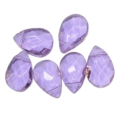 6 faceted teardrop-shaped purple gemstone cabochons arranged on a plain white background.