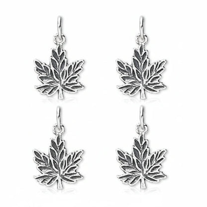 Four silver maple leaf dangle earrings on a plain white background.