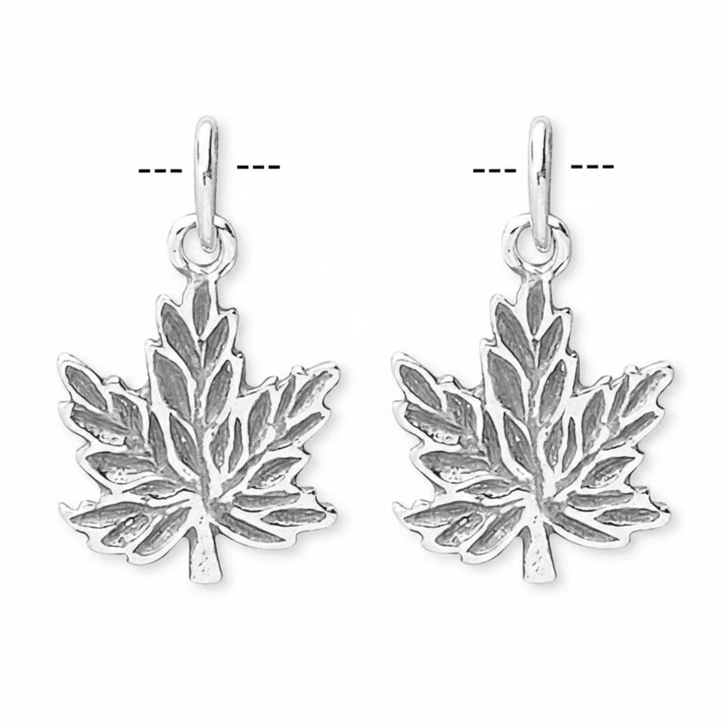 A pair of silver maple leaf dangle earrings with oxidized detailing in the recessed areas, shown against a plain white background.