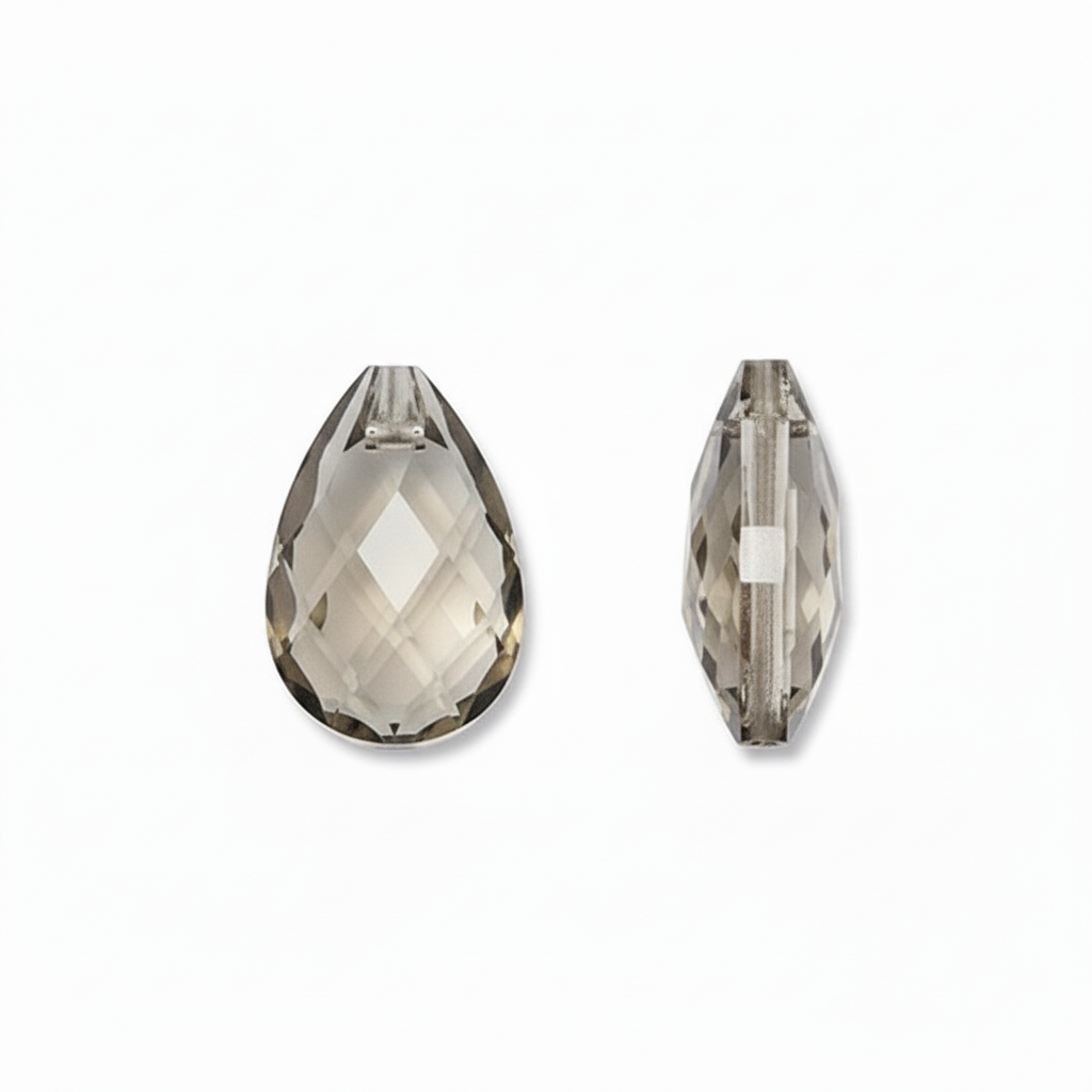Two faceted teardrop-shaped clear glass beads, one showing the front view and the other the side profile, on a plain white background.