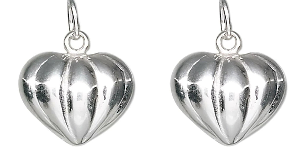 A pair of silver heart-shaped dangle earrings with a ribbed, textured surface and hanging loops, shown against a plain white background.