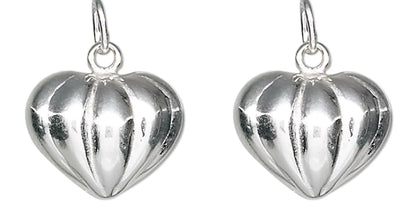 A pair of silver heart-shaped dangle earrings with a ribbed, textured surface and hanging loops, shown against a plain white background.