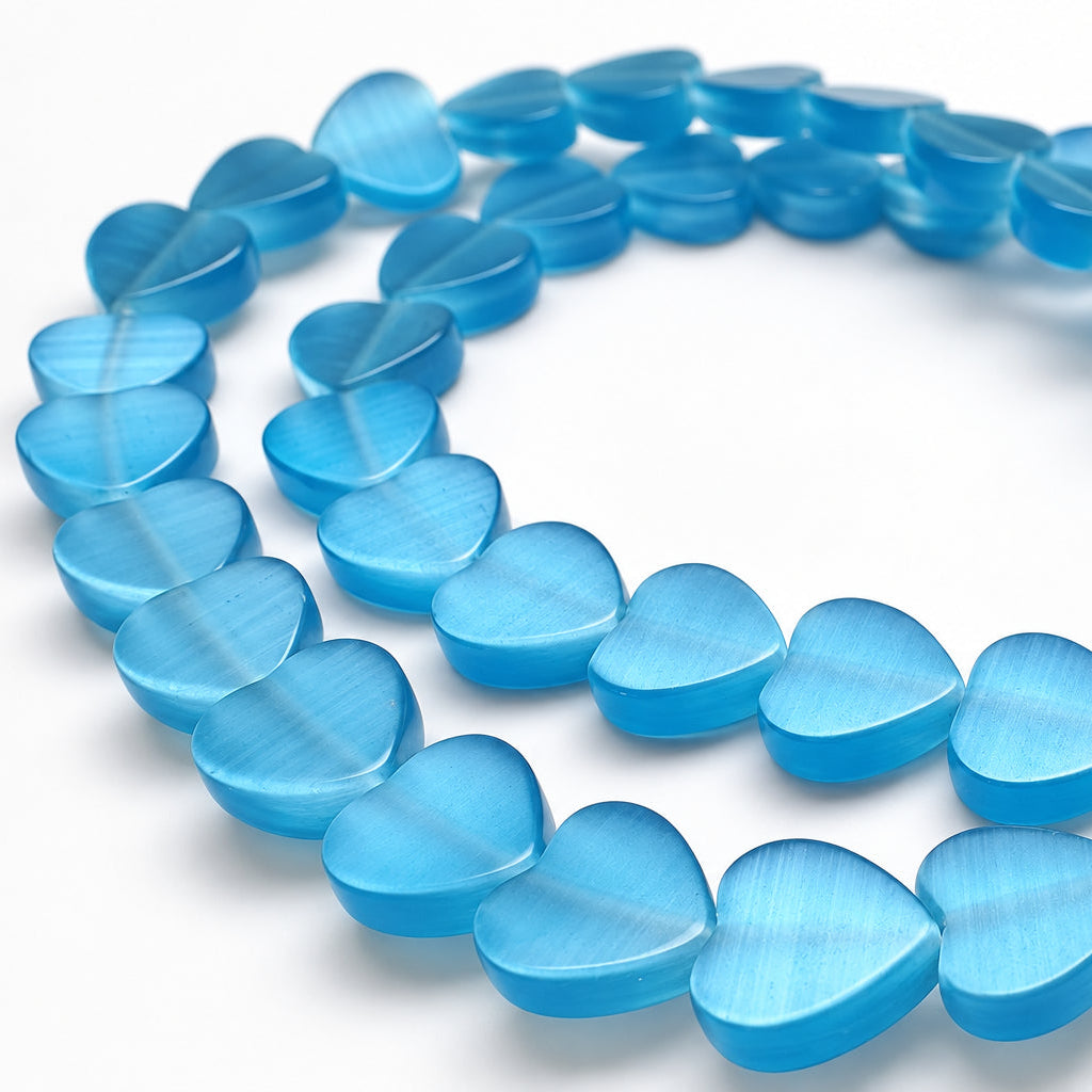 A strand of translucent light blue heart-shaped beads arranged in a loose circle on a plain white background.
